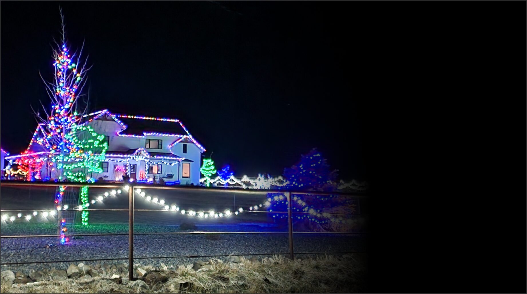 A home on the Western Slope lit for Christmas at dusk.
